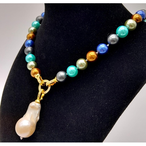 344 - A Colourful South Sea Pearl Shell Necklace with Hanging Large Baroque Pearl. Gilded and white stone ... 