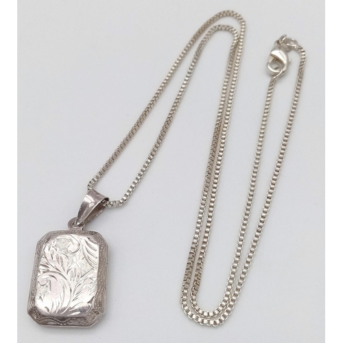 530 - A HAND ENGRAVED SILVER LOCKET IN A SQUARE SHAPE ON A 50cms SILVER BOX CHAIN .   8.8gms