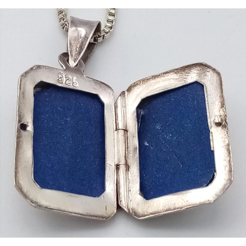 530 - A HAND ENGRAVED SILVER LOCKET IN A SQUARE SHAPE ON A 50cms SILVER BOX CHAIN .   8.8gms