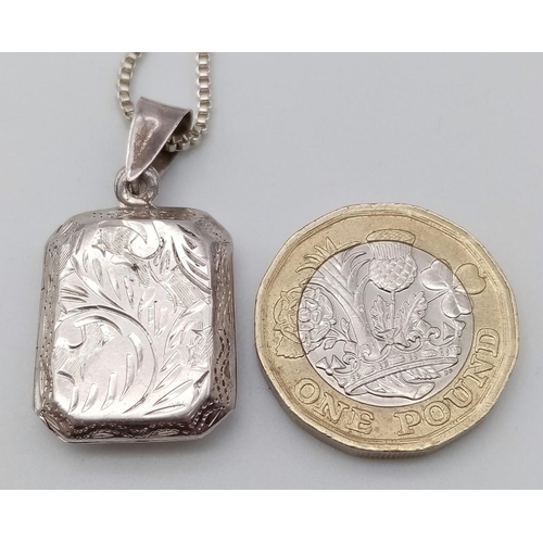 530 - A HAND ENGRAVED SILVER LOCKET IN A SQUARE SHAPE ON A 50cms SILVER BOX CHAIN .   8.8gms