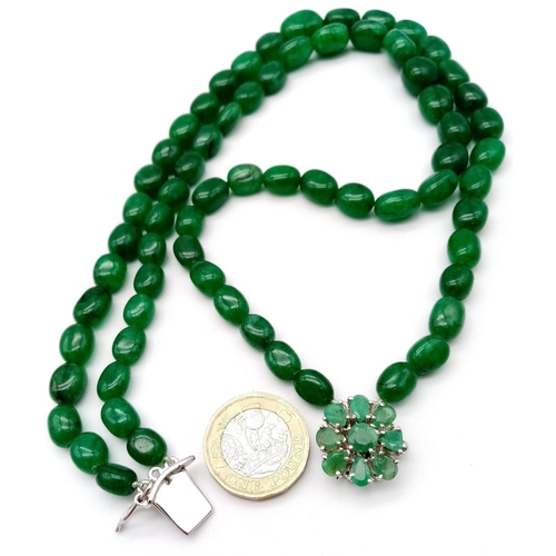 59 - A Two Strand Emerald Oval Beaded Necklace. With a matching gemstone and Silver Clasp. Beads-422ctw. ... 