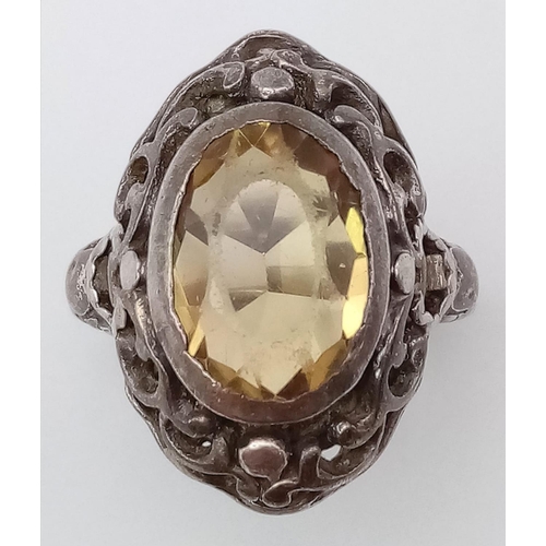 745 - A vintage silver lemon oval Citrine solitaire ring with further decoration surround. Total weight 6.... 