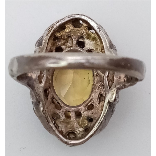 745 - A vintage silver lemon oval Citrine solitaire ring with further decoration surround. Total weight 6.... 