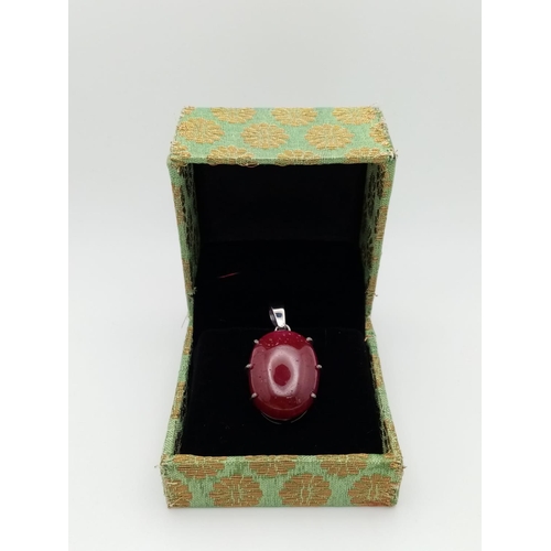 1021 - A Ruby Silver Pendant. Oval cut set in 925 Sterling silver. 57ctw. W-15.5g. 4cm. Ref: VO-1953. Comes... 