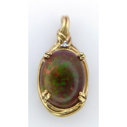 1144 - A BLACK OPAL SETIN A 9K GOLD PENDANT .   2.8gms