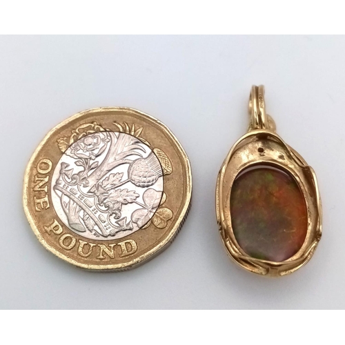 1144 - A BLACK OPAL SETIN A 9K GOLD PENDANT .   2.8gms