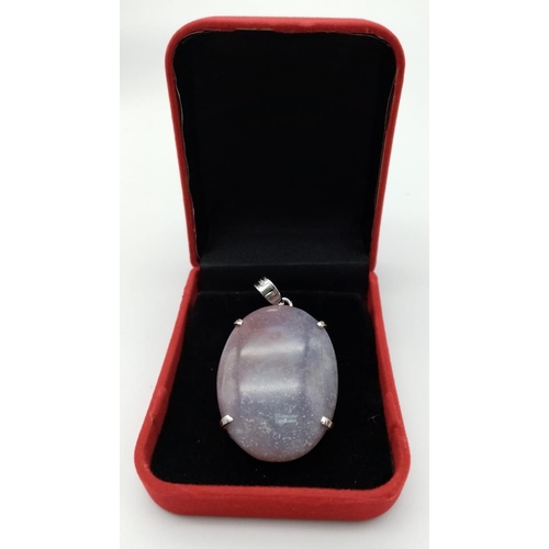 831 - An Oval Cut Corundum Agate set in 925 Silver Pendant. 70ct. W-26.80g. 6cm. Comes with a presentation... 