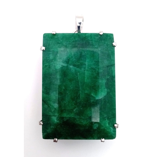 96 - A Large Rectangular Emerald Pendant set in 925 Sterling silver. 100ct. W-95.60g. 7cm. Comes with a p... 