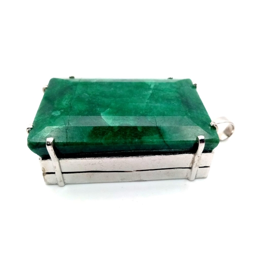 96 - A Large Rectangular Emerald Pendant set in 925 Sterling silver. 100ct. W-95.60g. 7cm. Comes with a p... 