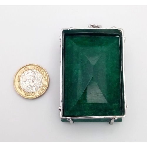 96 - A Large Rectangular Emerald Pendant set in 925 Sterling silver. 100ct. W-95.60g. 7cm. Comes with a p... 