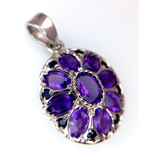 723 - An Amethyst Floral Pendant. Oval cut Amethysts set in 925 Sterling silver. 8ctw. W-5.3g. Ref: HV-200... 