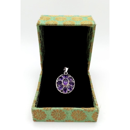 723 - An Amethyst Floral Pendant. Oval cut Amethysts set in 925 Sterling silver. 8ctw. W-5.3g. Ref: HV-200... 