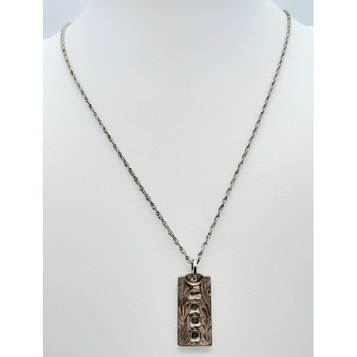 1023 - A vintage sterling silver ingot pendant on silver chain. Full hallmarks Birmingham, 1979. Total weig... 