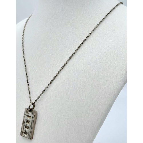 1023 - A vintage sterling silver ingot pendant on silver chain. Full hallmarks Birmingham, 1979. Total weig... 