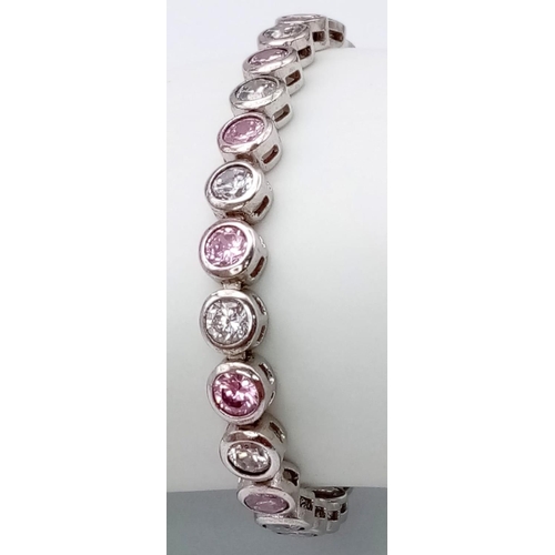 1311 - A STERLING SILVER WHITE & PINK STONE SET BRACELET. 15.1G