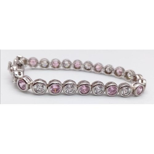 1311 - A STERLING SILVER WHITE & PINK STONE SET BRACELET. 15.1G