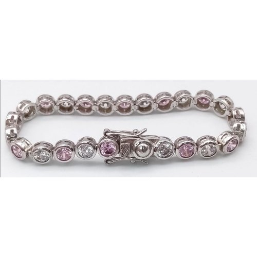 1311 - A STERLING SILVER WHITE & PINK STONE SET BRACELET. 15.1G