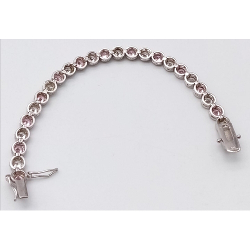 1311 - A STERLING SILVER WHITE & PINK STONE SET BRACELET. 15.1G