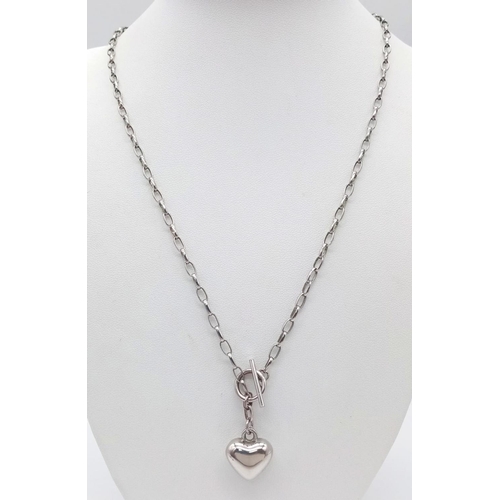 758 - A vintage 925 silver heart pendant on silver T-bar chain. Total weight 11.6G. Total length 48cm.