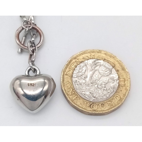 758 - A vintage 925 silver heart pendant on silver T-bar chain. Total weight 11.6G. Total length 48cm.