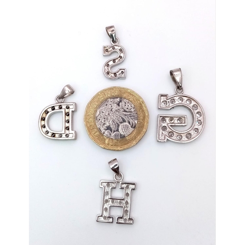 1403 - A SELECTION OF 4 STERLING SILVER STONE SET INITIAL PENDANTS H, S, D & G. 8.3G.