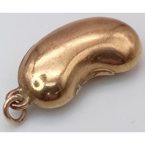 1432 - A 9K YELLOW GOLD BEAN CHARM. 0.9G