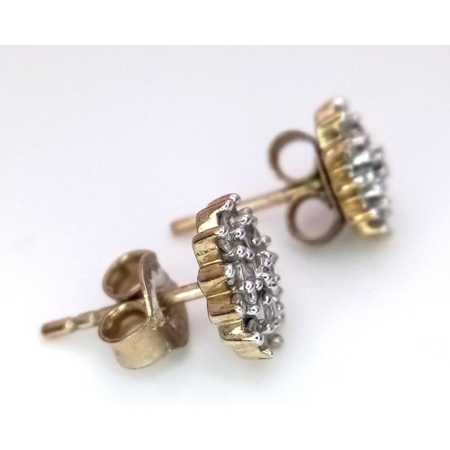 1439 - A PAIR OF 9K YELLOW GOLD DIAMOND SET CLUSTER STUD EARRINGS. 1.5G