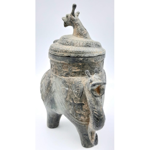 716 - An Antique Chinese Bronze Lidded Water Vessel with Dragon's Head Decoration. 27cm tall.