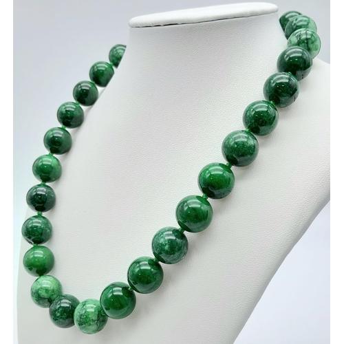 531 - A Chinese Green and White Jade Bead Necklace. 14mm beads. 42cm necklace length.