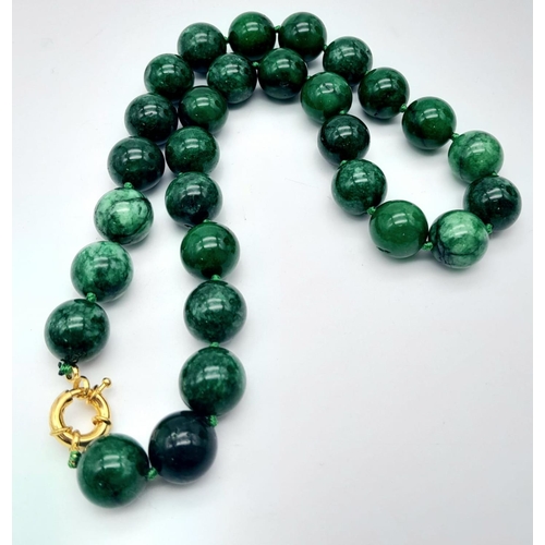 531 - A Chinese Green and White Jade Bead Necklace. 14mm beads. 42cm necklace length.