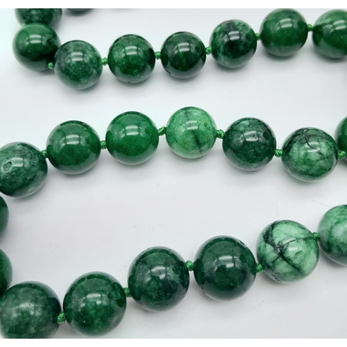 531 - A Chinese Green and White Jade Bead Necklace. 14mm beads. 42cm necklace length.