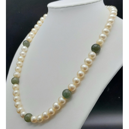 589 - A Cultured White Pearl and Jade Necklace with a 9K Yellow Gold Clasp. 46cm length.