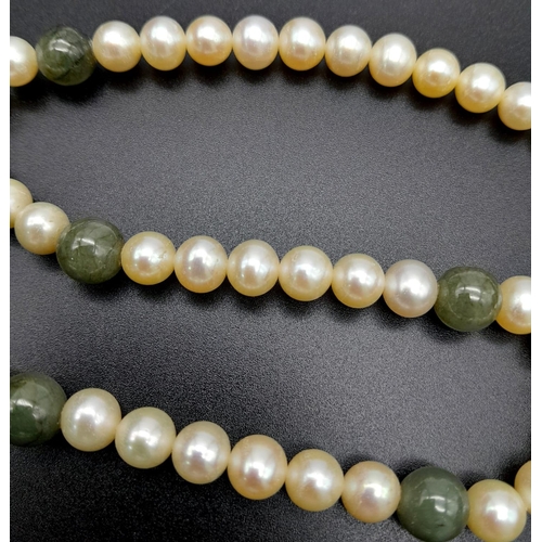 589 - A Cultured White Pearl and Jade Necklace with a 9K Yellow Gold Clasp. 46cm length.