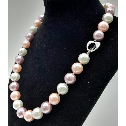 734 - A South Sea Pearl Shell Pastel Coloured Bead Necklace. 12mm beads. 44cm necklace length.