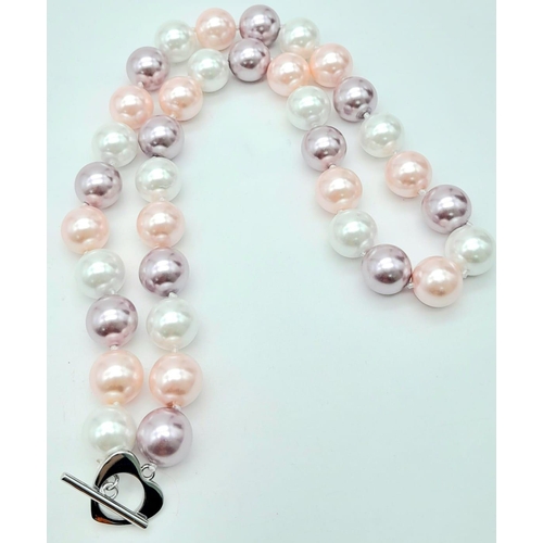 734 - A South Sea Pearl Shell Pastel Coloured Bead Necklace. 12mm beads. 44cm necklace length.