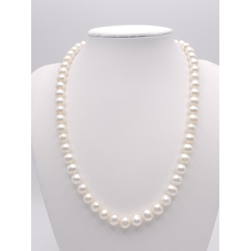 736 - A Cultured White Pearl Necklace with a 9K Yellow Gold Clasp. 
42cm.