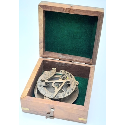 841 - A Portable Folding Bronze Sundial/Compass in its own Wooden Presentation Case. 7.5cm. In good condit... 