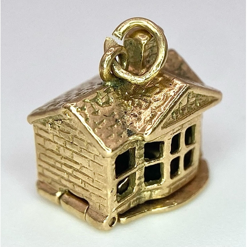 724 - A 9K yellow gold opening house charm. 2.7g