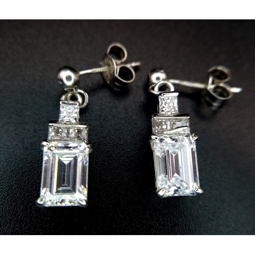 1303 - A pair of 9k white gold drop earrings - set with cubic zirconia. 3.1g