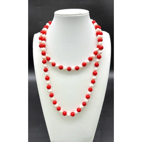 937 - A Matinee Length Red Coral and Cultured Pearl Necklace. 7/8mm pearls and beads. 88cm length.