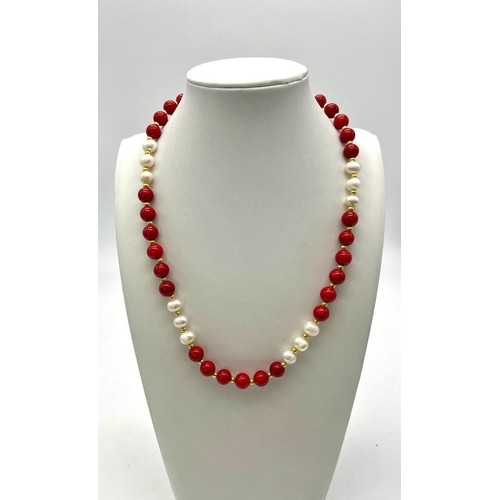 922 - A Red Coral and White Akoya Pearl Necklace. 7/8mm beads. 44cm necklace length. Gilded spacers and cl... 