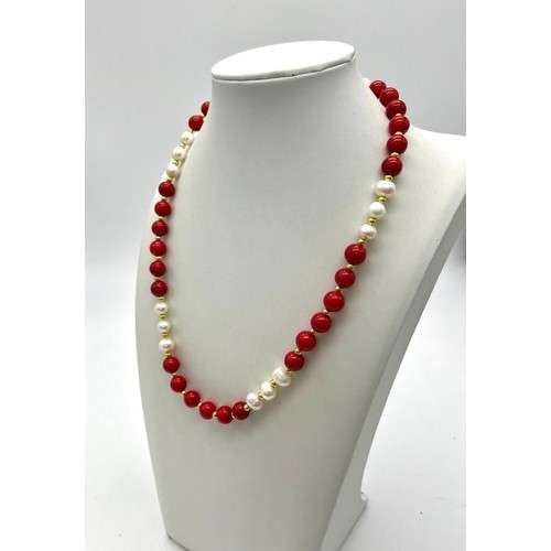 922 - A Red Coral and White Akoya Pearl Necklace. 7/8mm beads. 44cm necklace length. Gilded spacers and cl... 