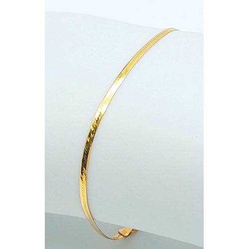 1447 - A Wafer-Thin 9K Yellow Gold Herringbone Bracelet. 17cm. 1g weight.