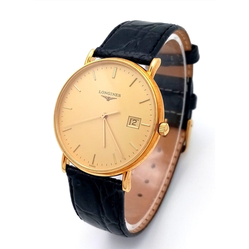 24 - A Longine 18K Gold Cased Gents Watch. Black leather strap. 18k gold case - 33mm. Gilded dial with da... 