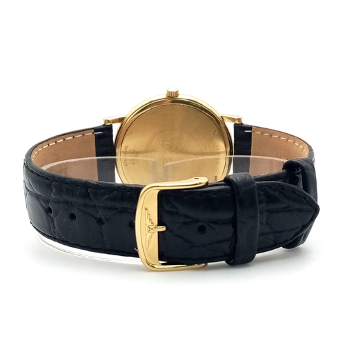 24 - A Longine 18K Gold Cased Gents Watch. Black leather strap. 18k gold case - 33mm. Gilded dial with da... 