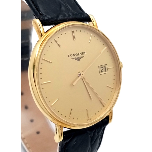 24 - A Longine 18K Gold Cased Gents Watch. Black leather strap. 18k gold case - 33mm. Gilded dial with da... 