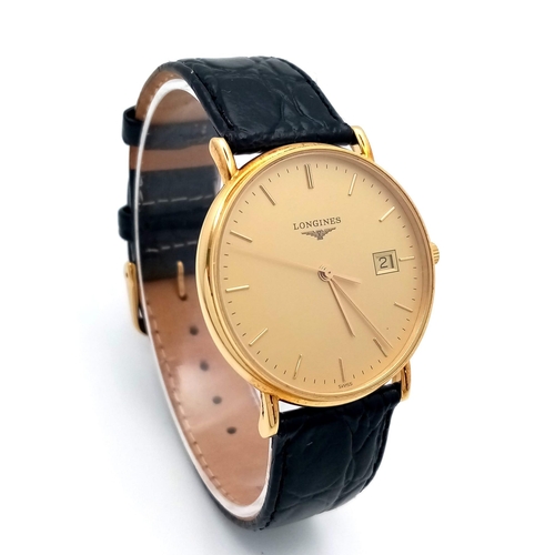 24 - A Longine 18K Gold Cased Gents Watch. Black leather strap. 18k gold case - 33mm. Gilded dial with da... 