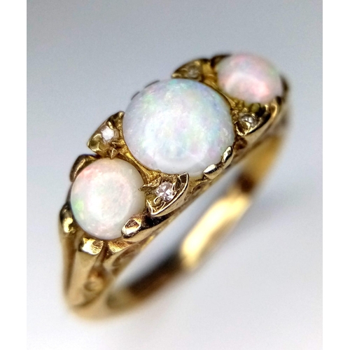 40 - A Wonderful Vintage 9K Yellow Gold and Three Opal Ring. Excellent colour-play. Size I. 3.25g weight.