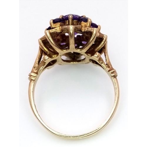 68 - A Vintage 9K Yellow Gold Amethyst Ring. Central oval cut amethyst with an amethyst halo. Size M. 4.2... 