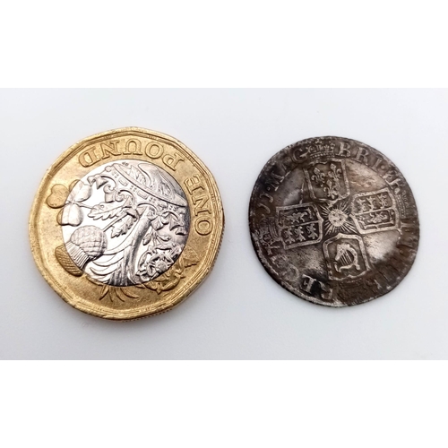 820 - A 1711 Queen Anne Silver Sixpence. Please see photos for conditions.